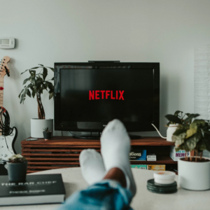 Streaming Netflix through a Proxy on a living room TV, with viewer sticking their feet up on a coffee table