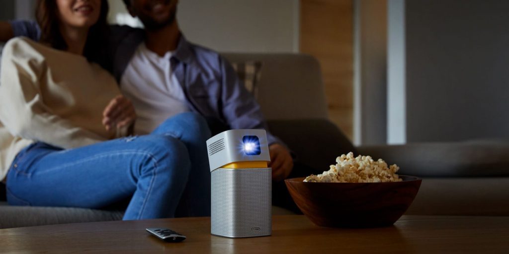 BenQ GV1 Portable Projector on a table next to popcorn