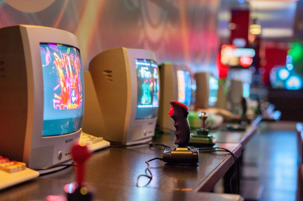 Retro Gaming Consoles set up on a bench for gamers to play