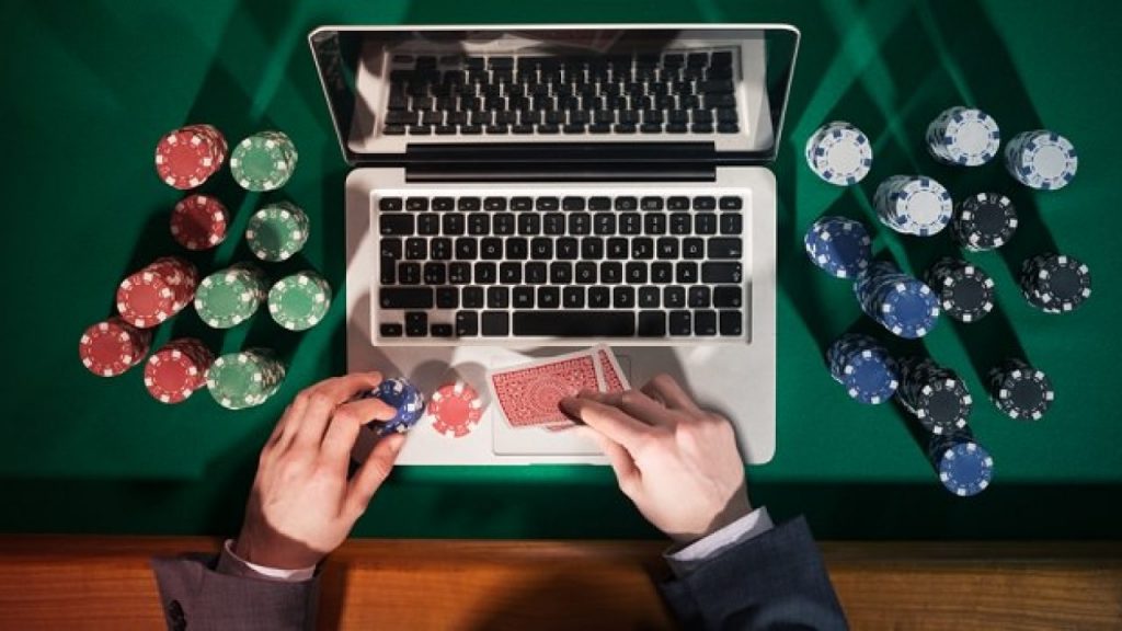 Chips and cards on a laptop for online gambling