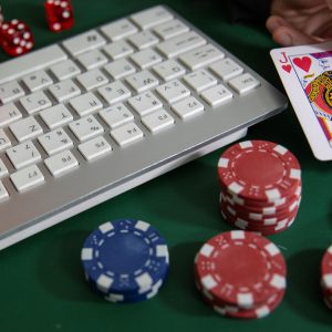 Chips, cards and dice next to a keyboard