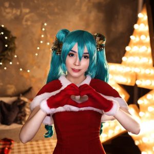 Cute cosplayer girl cosplaying Christmas Miku Santa dress around