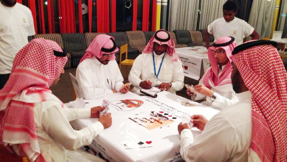 Card games like Baloot are popular in Arab countries. Group of men can be seen here playing the game.