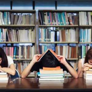 Stressed Students sat in a library with burnout