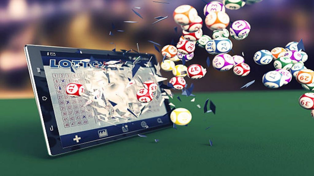 Tablet showing the ability to play online bingo anywhere, bingo balls popping out of the screen
