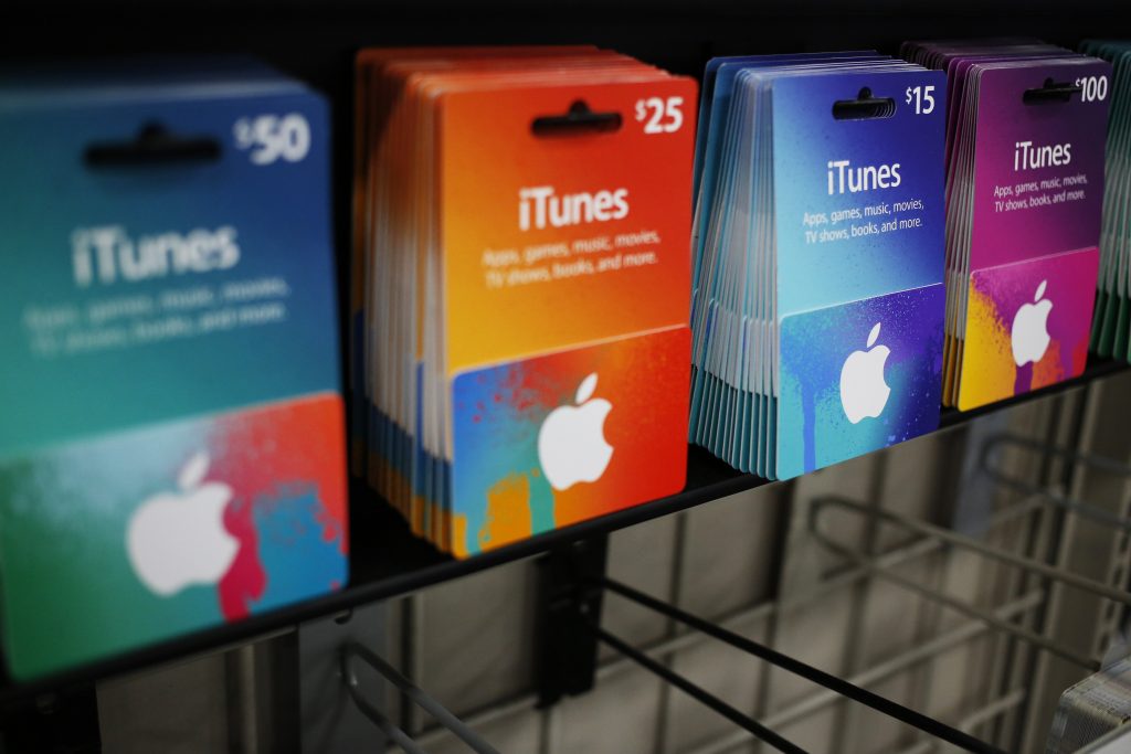 Apple Inc. iTunes gift cards are displayed for sale in a Best Buy Co. store in Chesapeake, Virginia, U.S., on Thursday, Nov. 26, 2015. In 2011, several big U.S. retailers moved their opening times to midnight; in 2012, Wal-Mart crossed the Rubicon and opened its stores at 8 p.m. on Thanksgiving Day. But after last year's Thanksgiving weekend retail sales fell 11 percent from the year before while overall holiday sales rose, some retailers have been reconsidering. Photographer: Luke Sharrett/Bloomberg via Getty Images