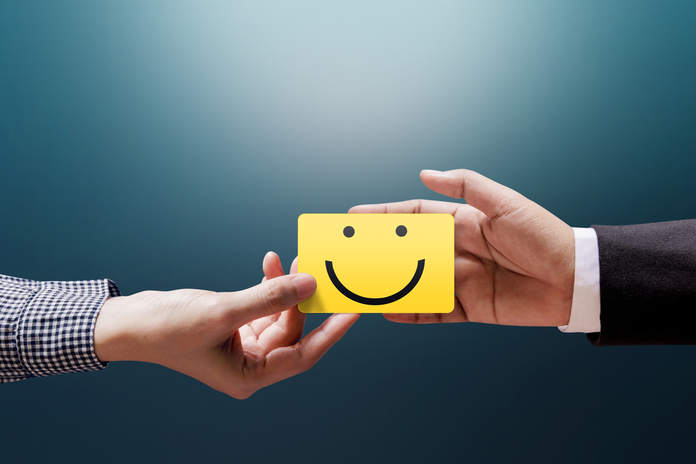 Customer Satisfaction displayed with a smiley face on a sticky note