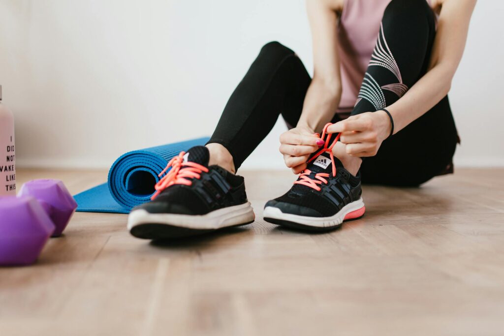 Person tying their laces getting ready for a fitness workout.