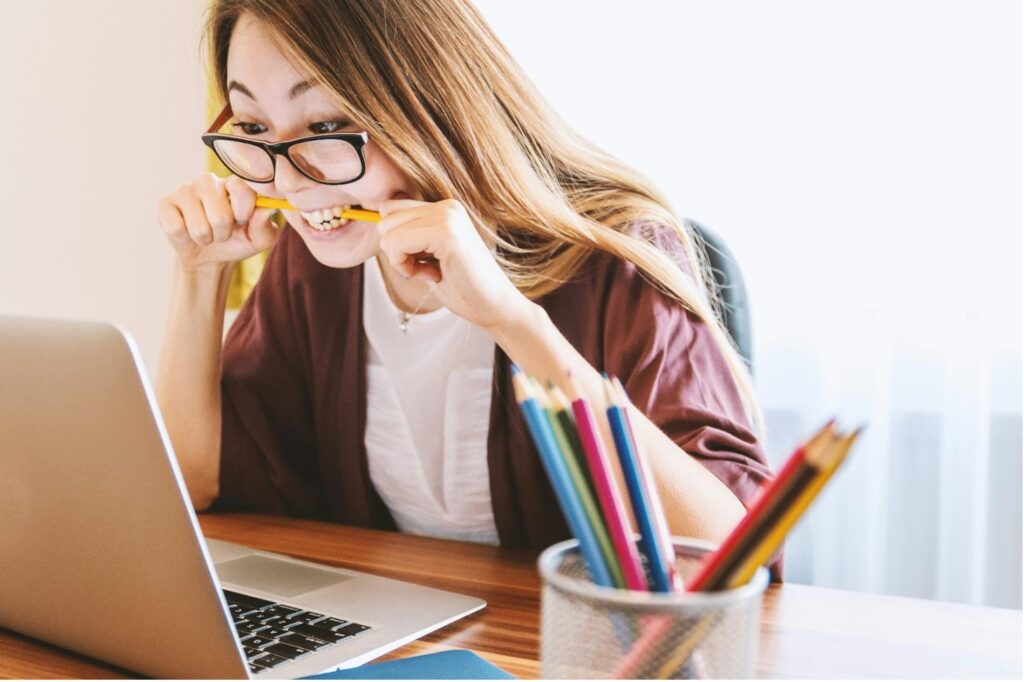 College Student biting pencil