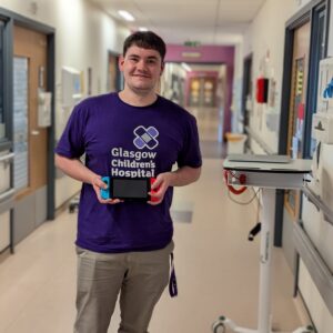 Gamer-in-Residence, Steven Mair holding a Nintendo Switch on a ward