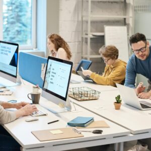 People Working in front of the Computer managing IT Solutions for Operating businesses