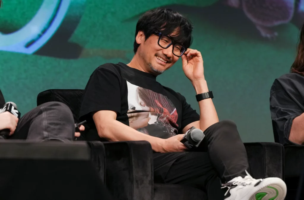 Death Stranding 2: On the Beach launches June 26th with pre-orders opening soon 4 Hideo Kojima on a chair at an event