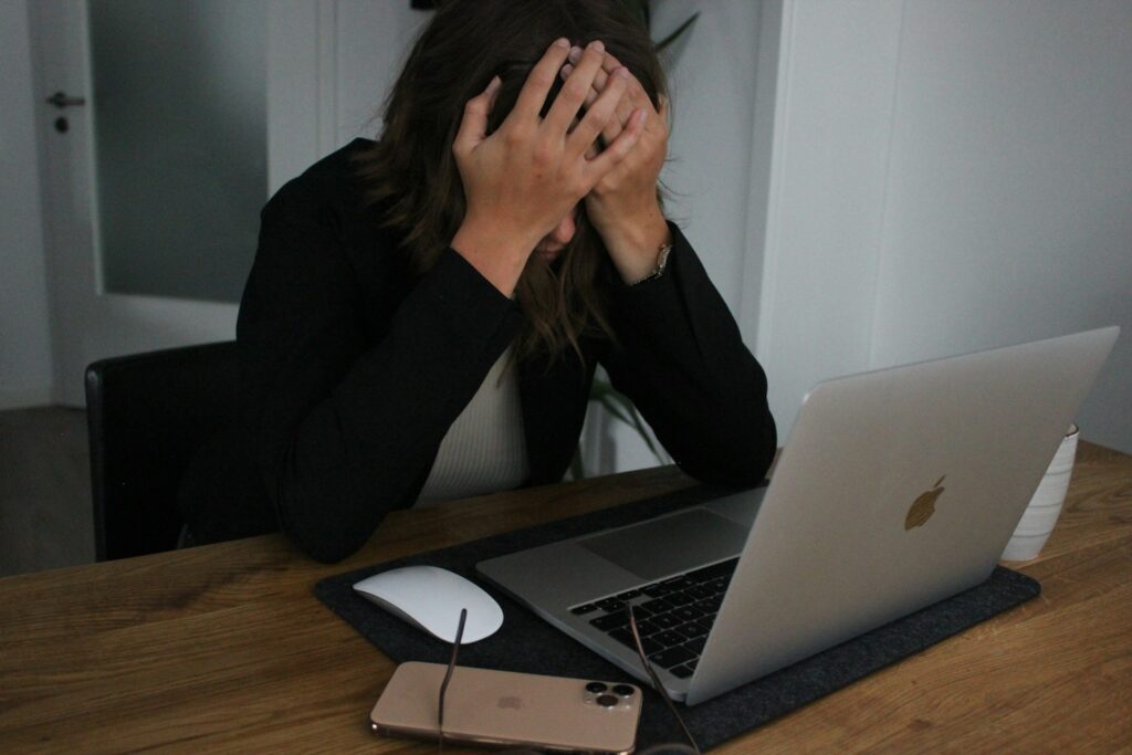 Building up your business’ online reputation 3 Woman at a Laptop with her head in her hands as she's fallen victim to a cybercrime for scammers probably using SEO