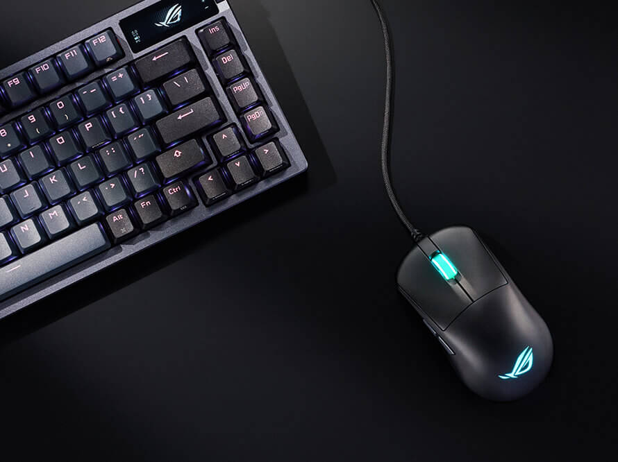 ASUS ROG Harpe Mini Core wired mouse on a mousemat next to keyboard