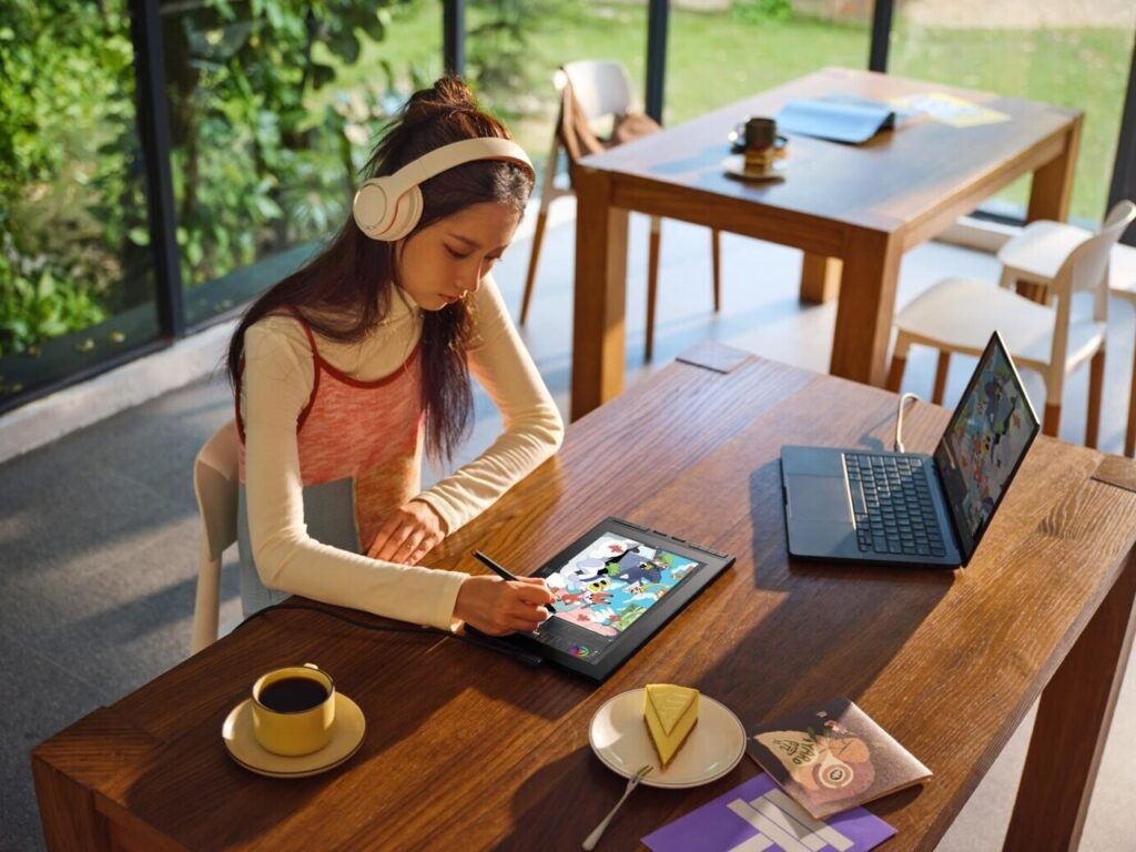 Woman using the XPPen Artist 12 3rd drawing display outdoors